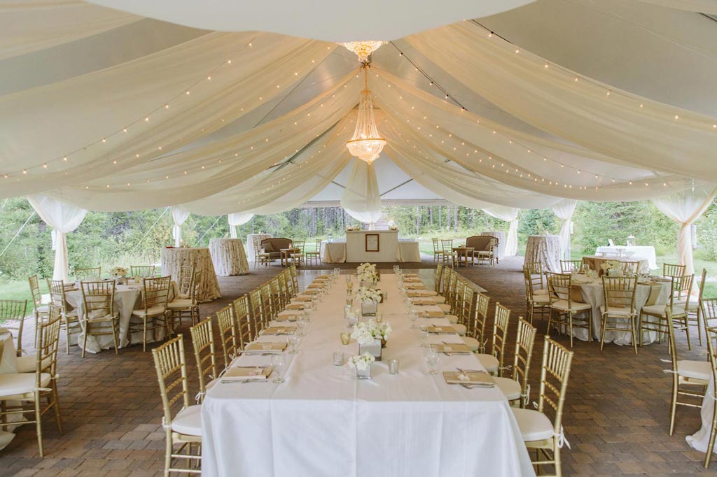 Outdoor tent decorated for a wedding.