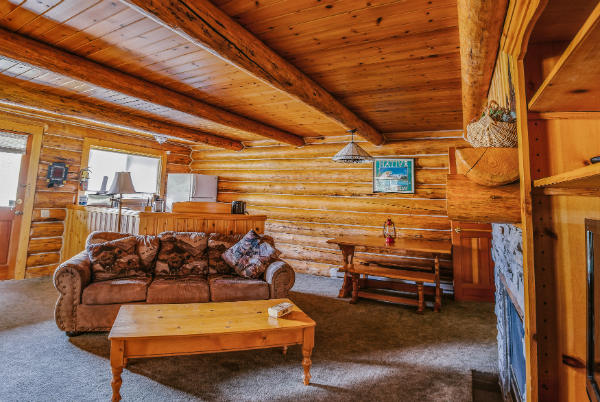 ID: a photograph of the inside of a wood-finished cabin. End ID.